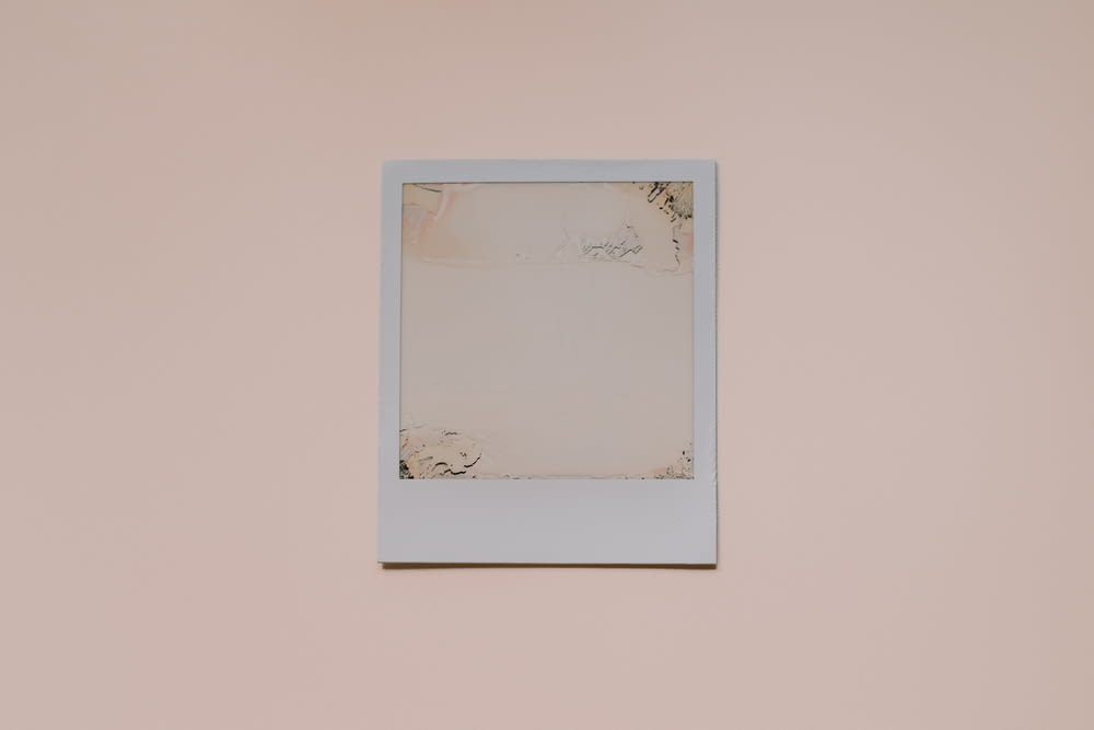 a white picture frame hanging on a wall