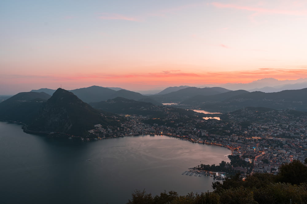 a sunset view of a city and a body of water