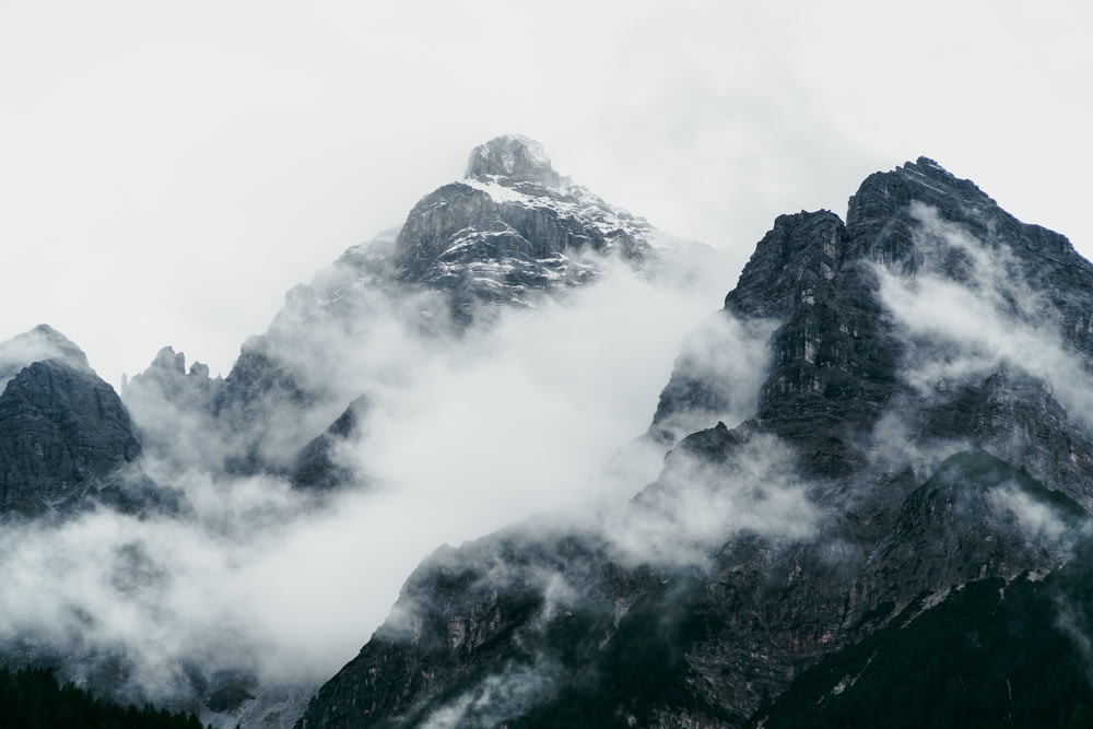 a mountain range covered in clouds and fog