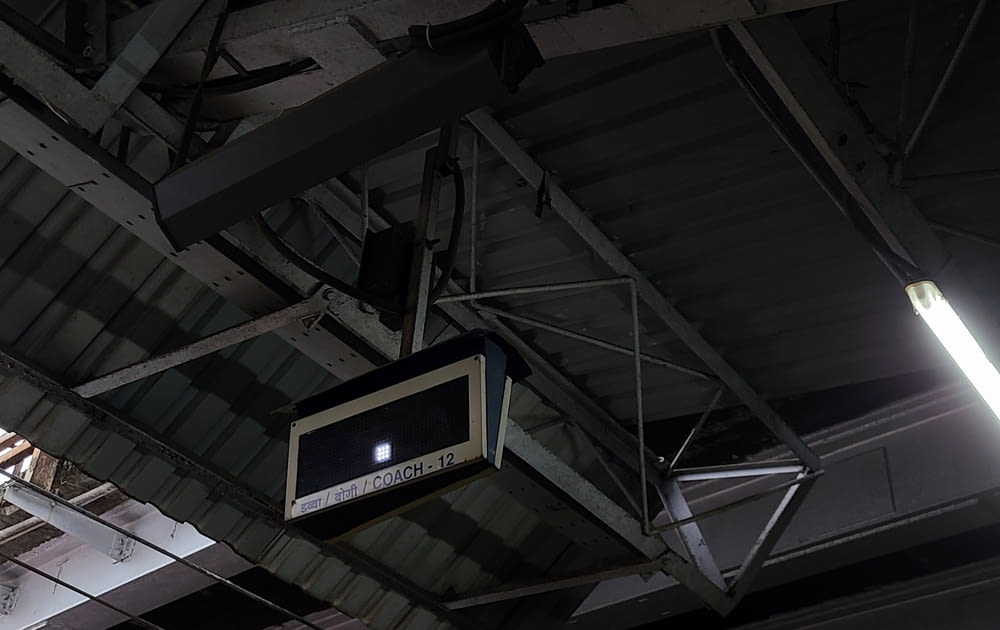 a television hanging from the ceiling of a building
