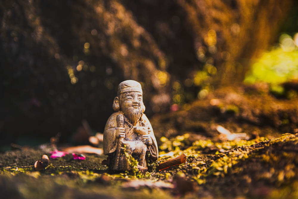 a small buddha statue sitting on the ground