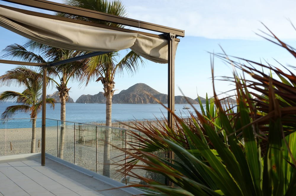 a balcony with a view of the ocean and mountains