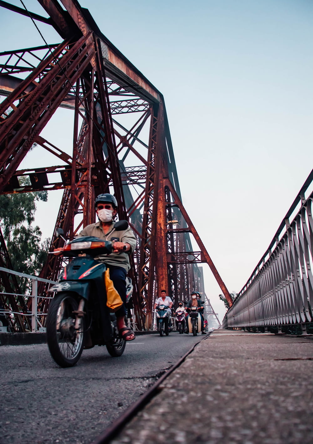 a person riding a motorcycle on a bridge
