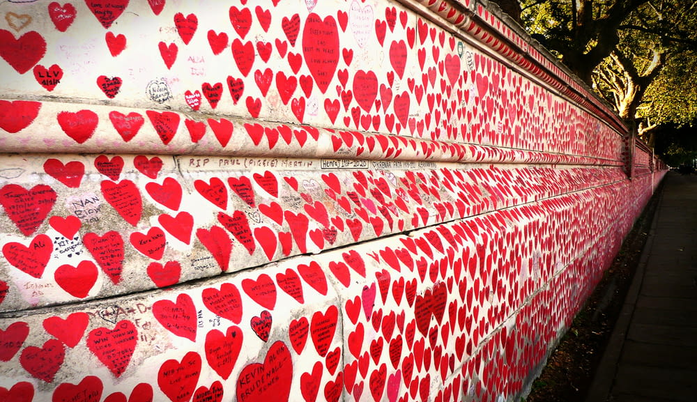 a red and white wall covered in lots of hearts