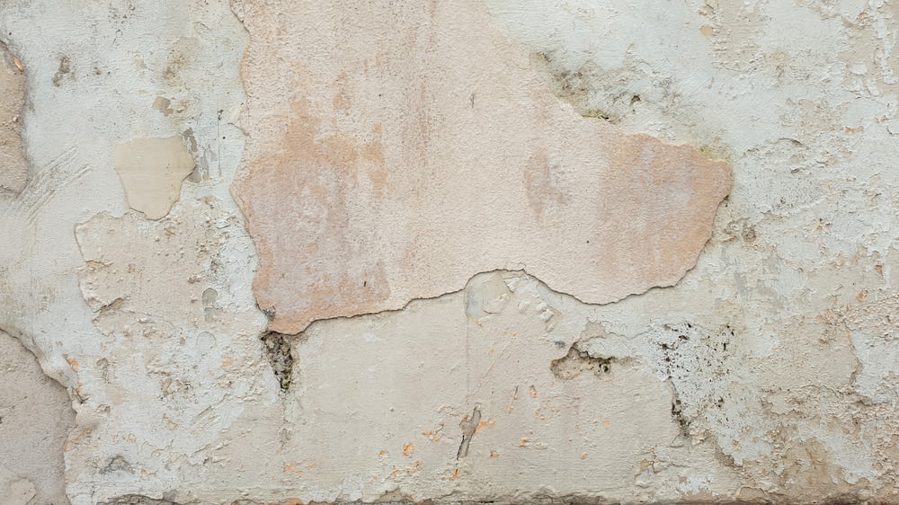 an old wall with peeling paint on it