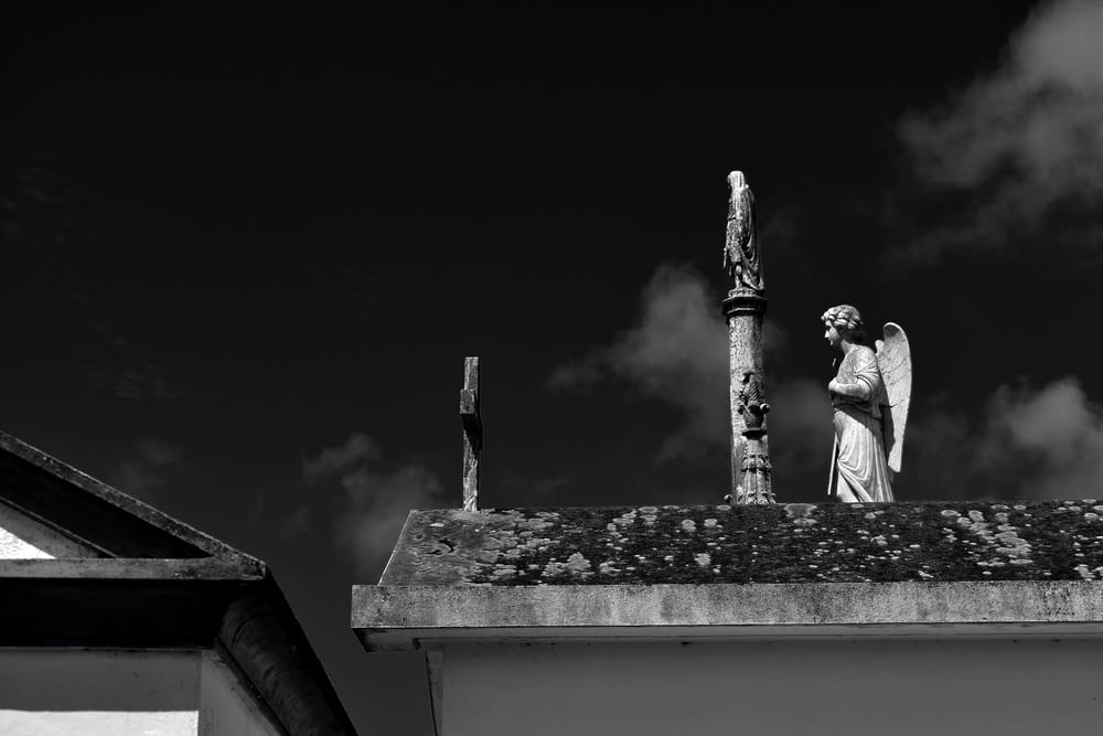a statue of an angel on top of a building