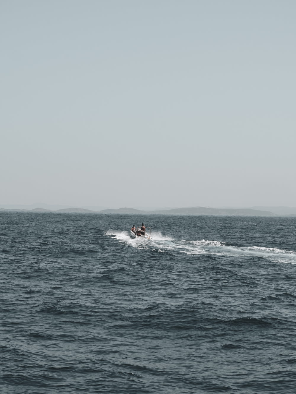 a person on a boat in the middle of the ocean