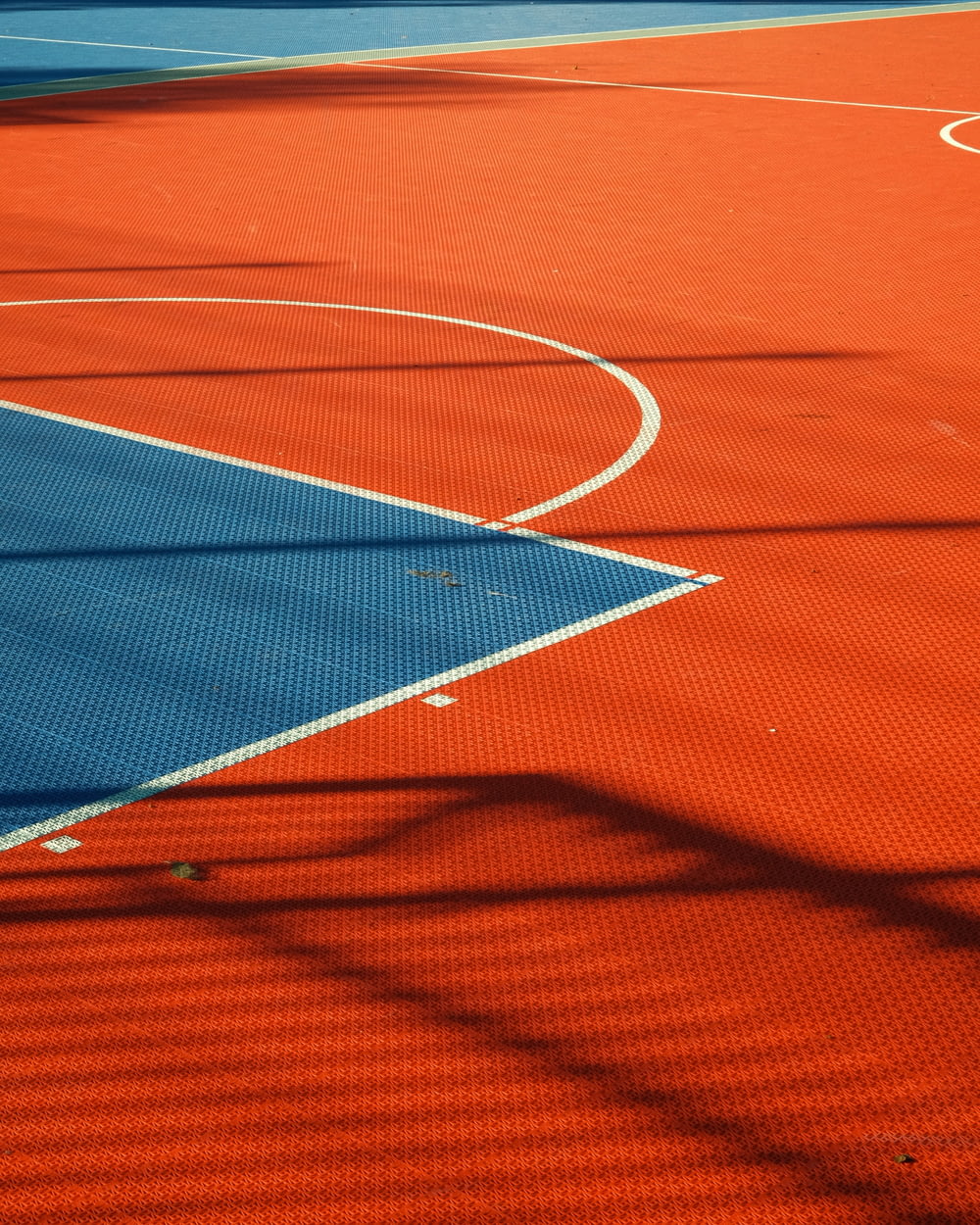 a basketball court with a blue and red court