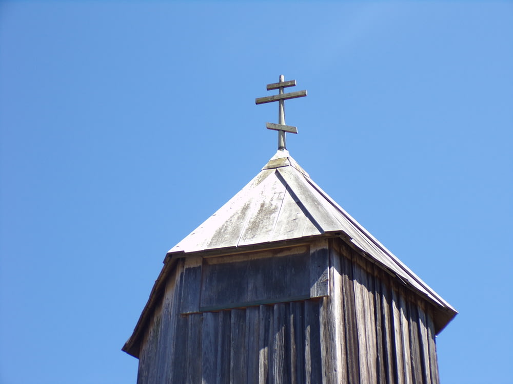 a cross on top of a wooden building