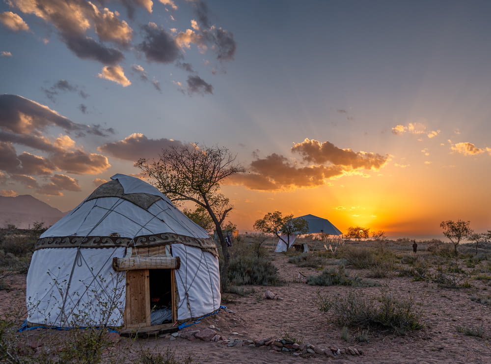 a yurt sitting in the middle of a desert