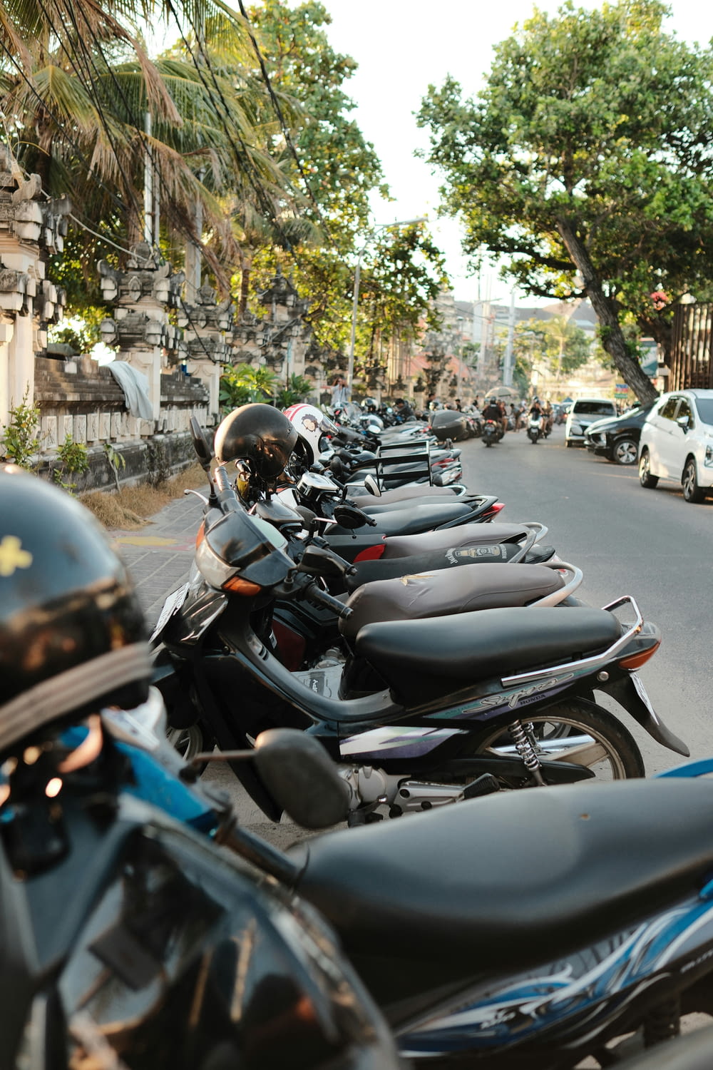 a row of motorcycles parked on the side of a street
