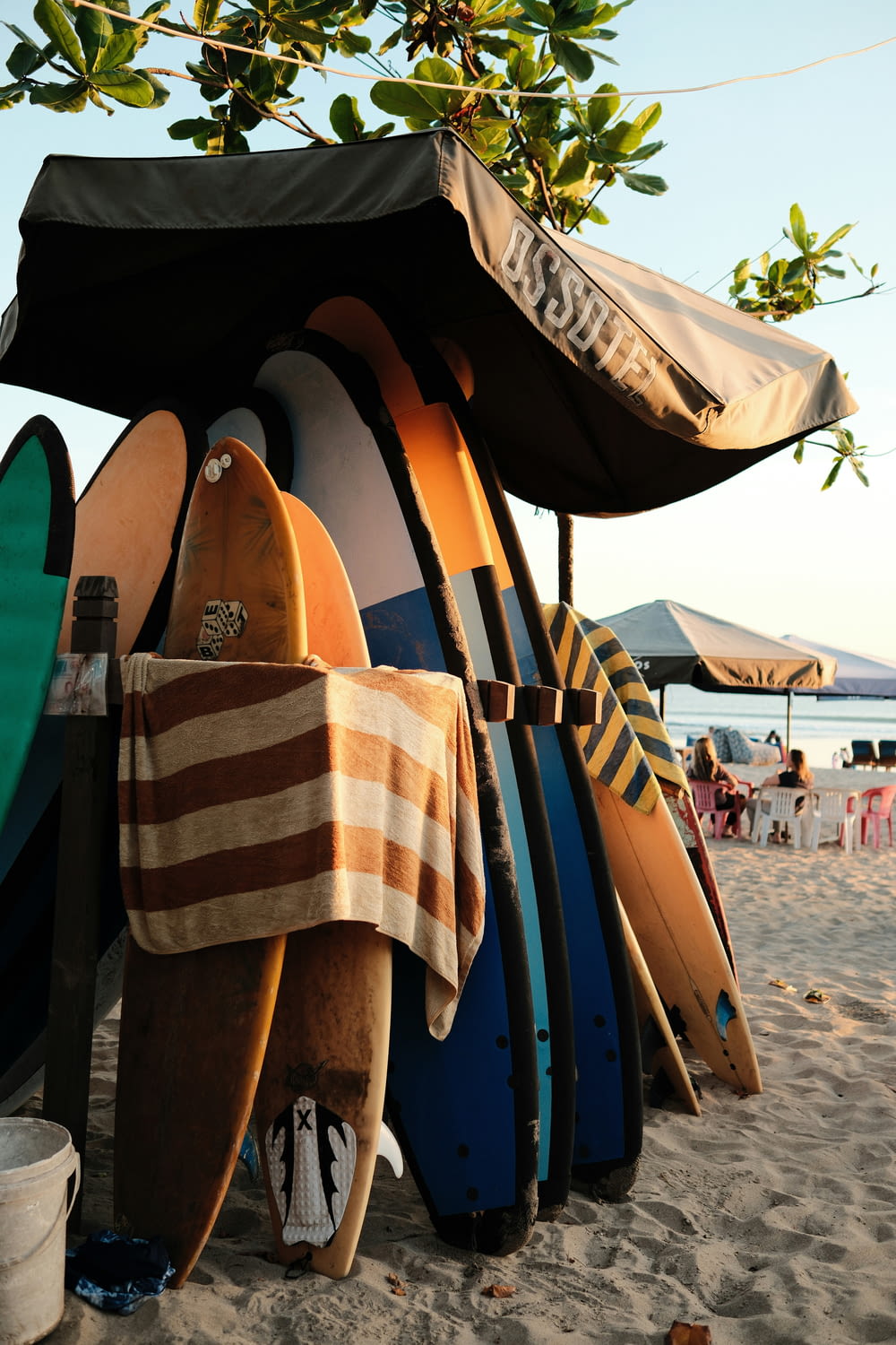 a bunch of surfboards are lined up on the beach