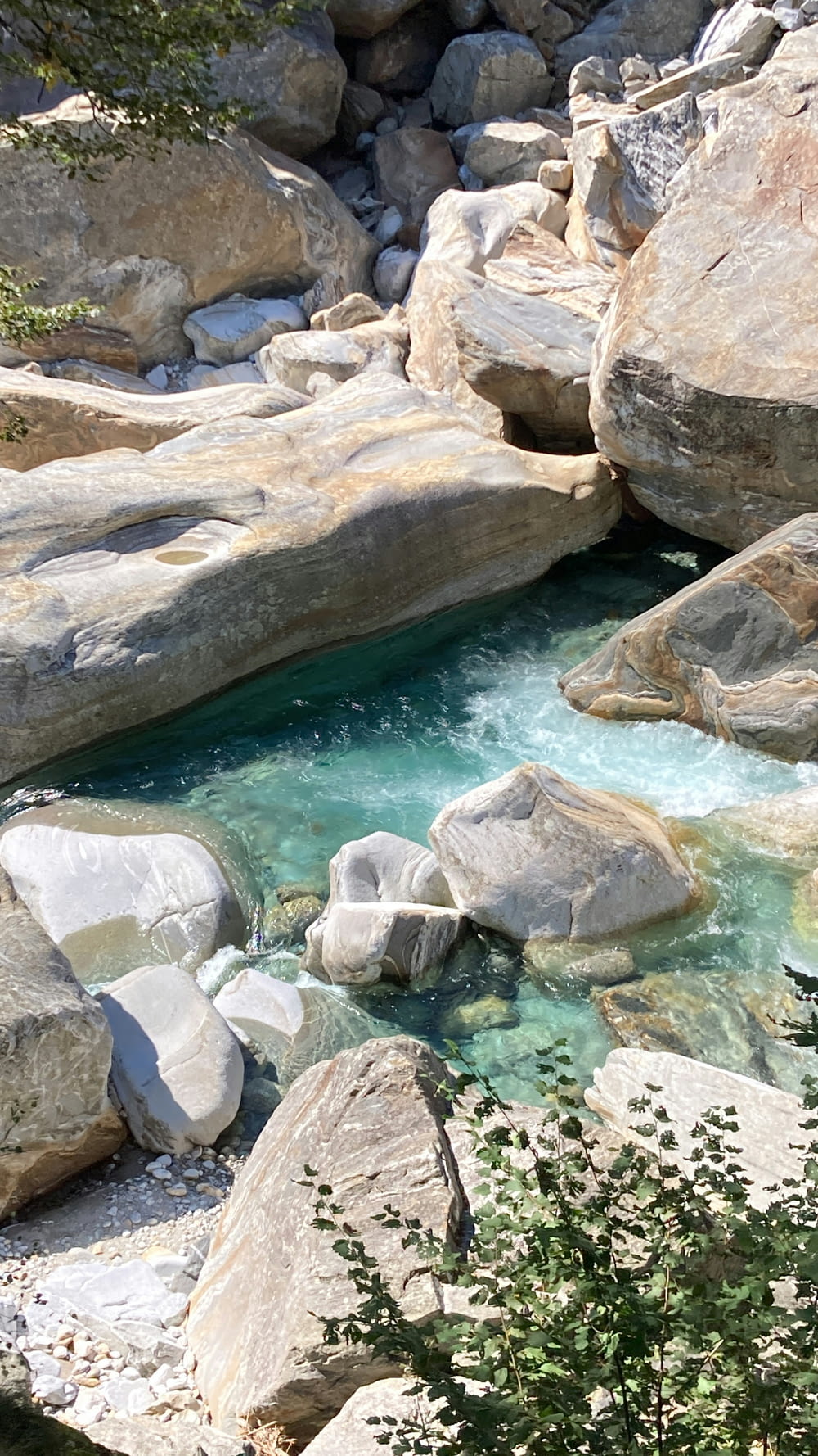 a small pool of water surrounded by rocks