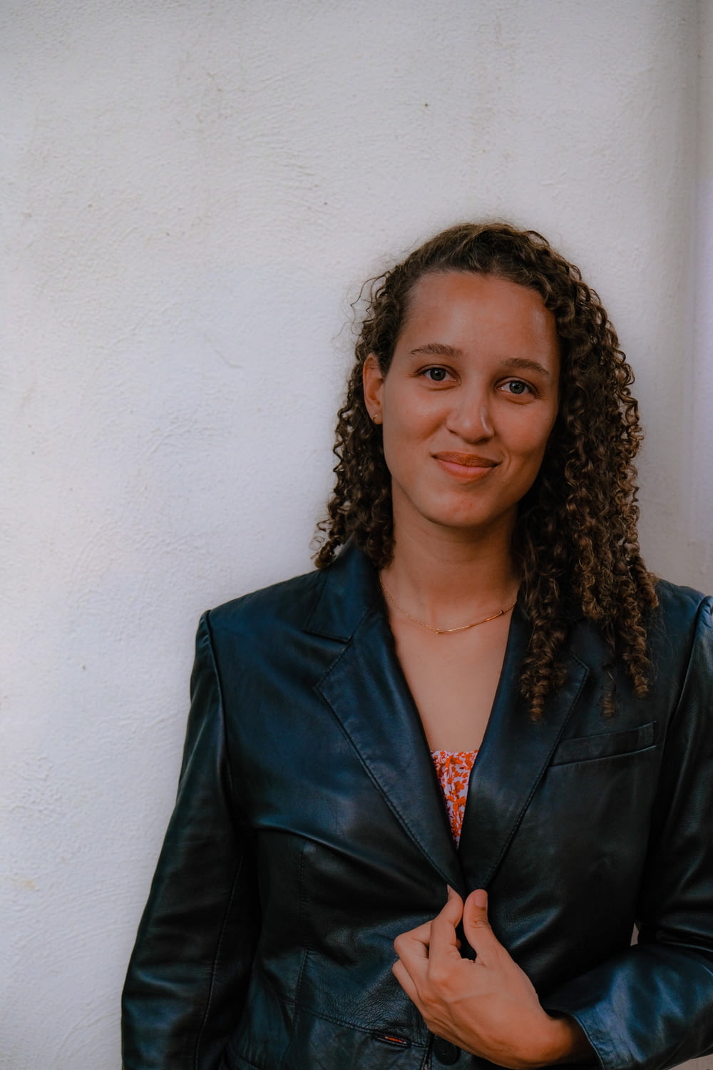 a woman in a black leather jacket posing for a picture
