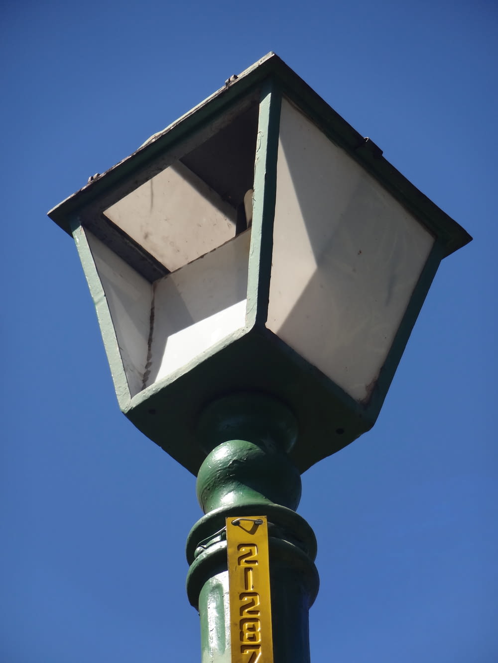 a street light with a yellow sign on it