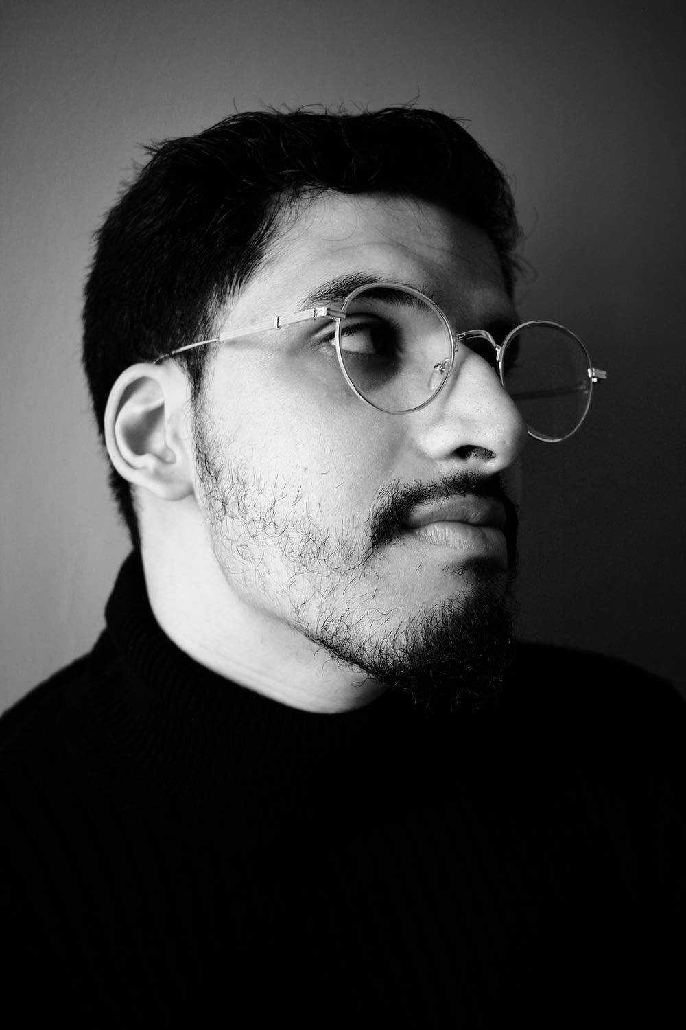 a man with a beard wearing glasses