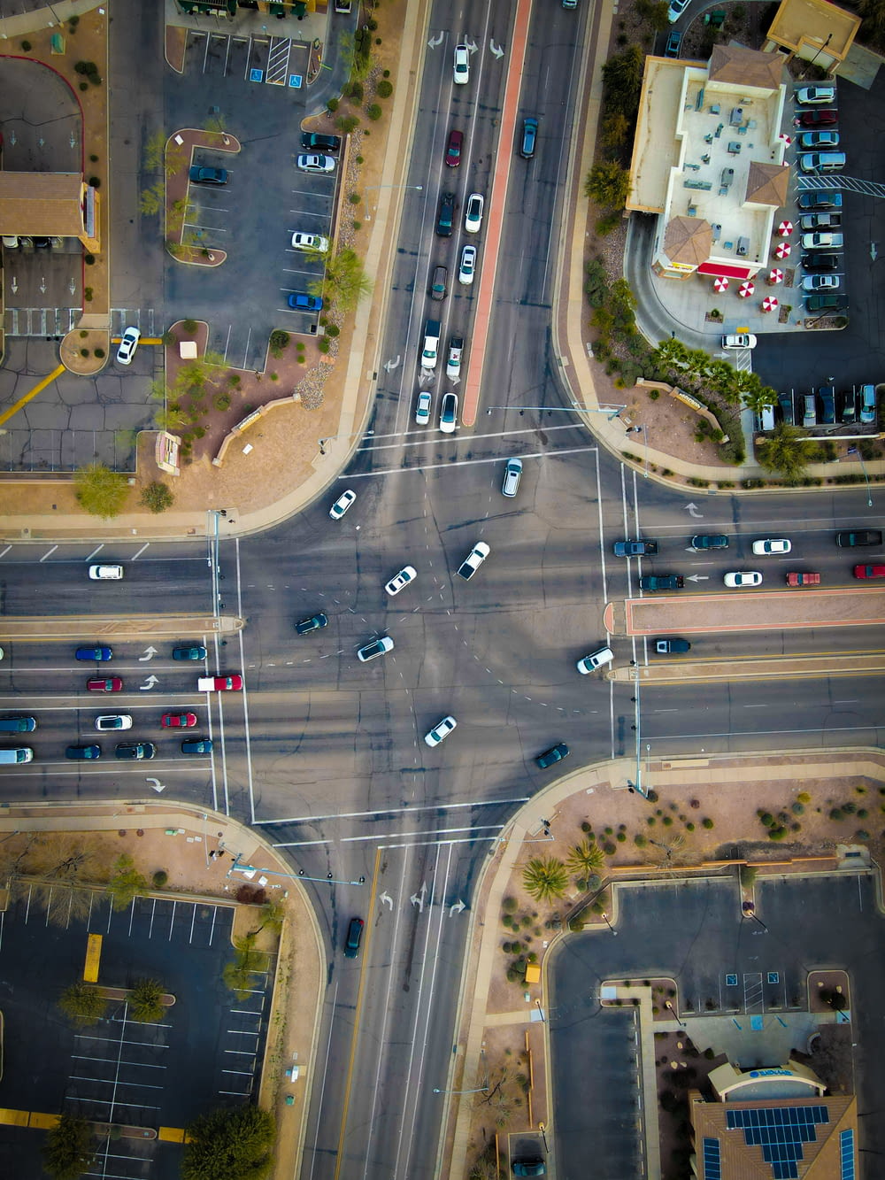 an aerial view of a street intersection with cars