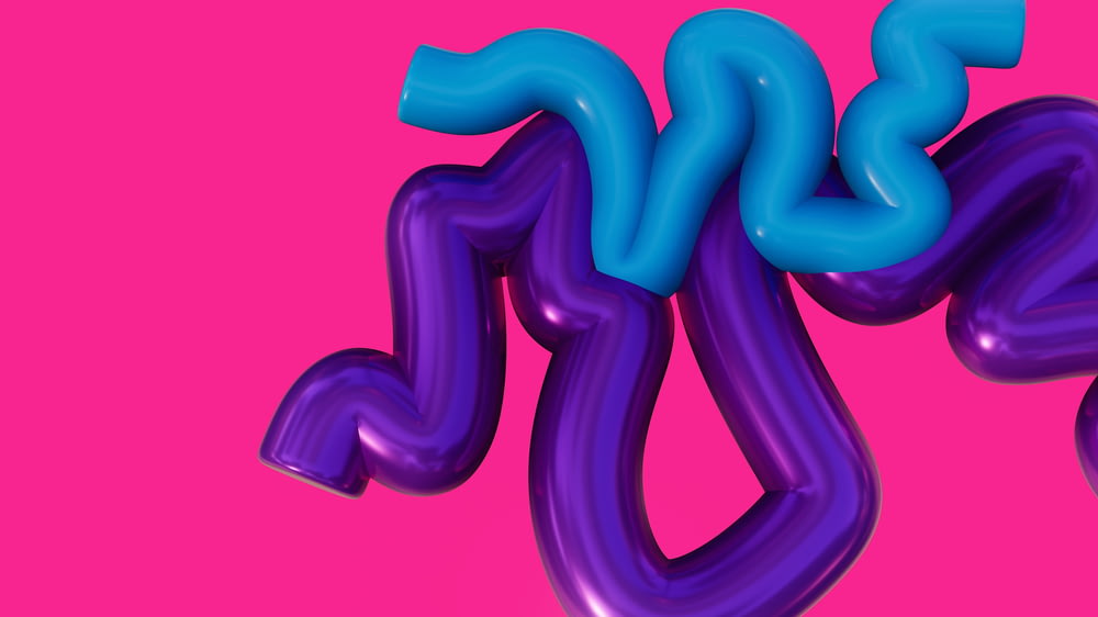 a purple and blue balloon type object on a pink background