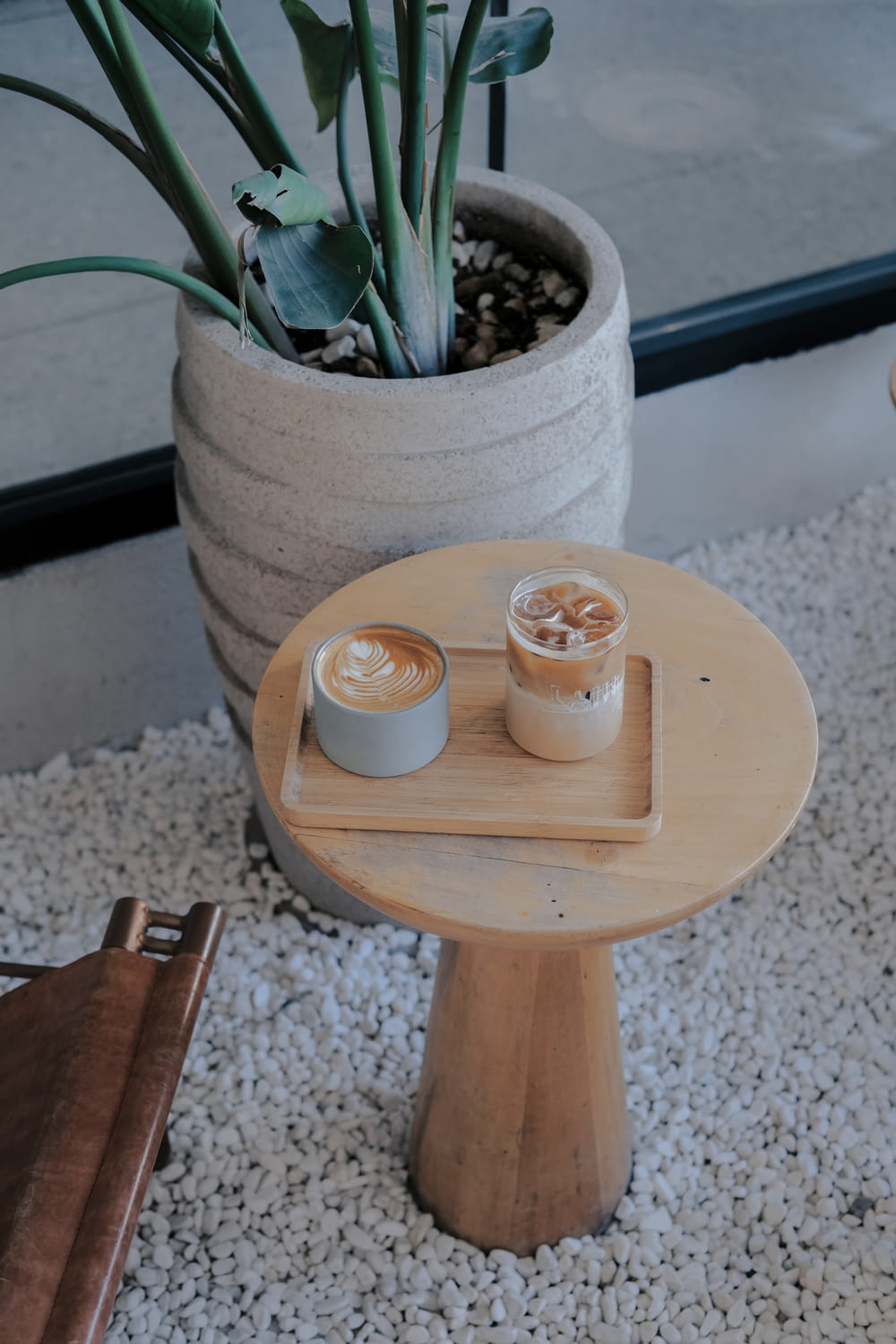 two cups of coffee sit on a small table
