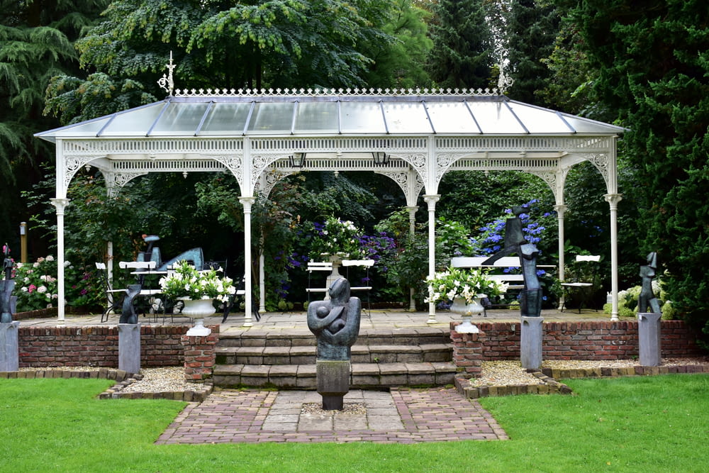 a gazebo with a statue of a man in the middle of it