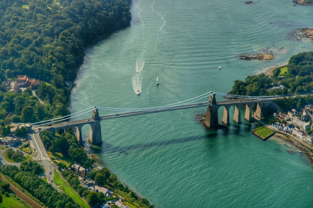 an aerial view of a bridge spanning the width of a river