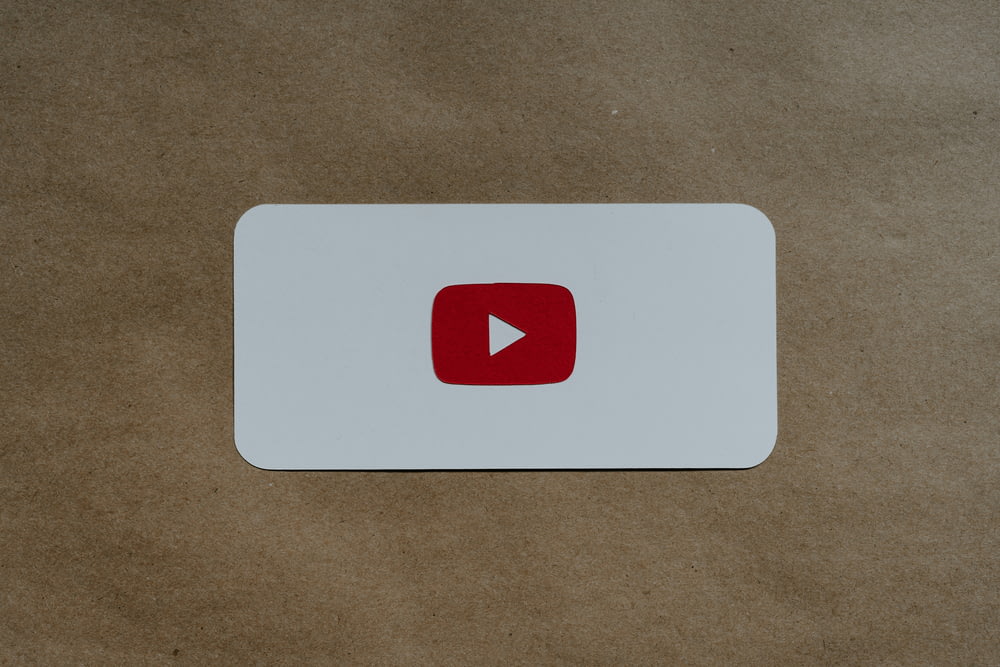 a white card with a red youtube logo on it