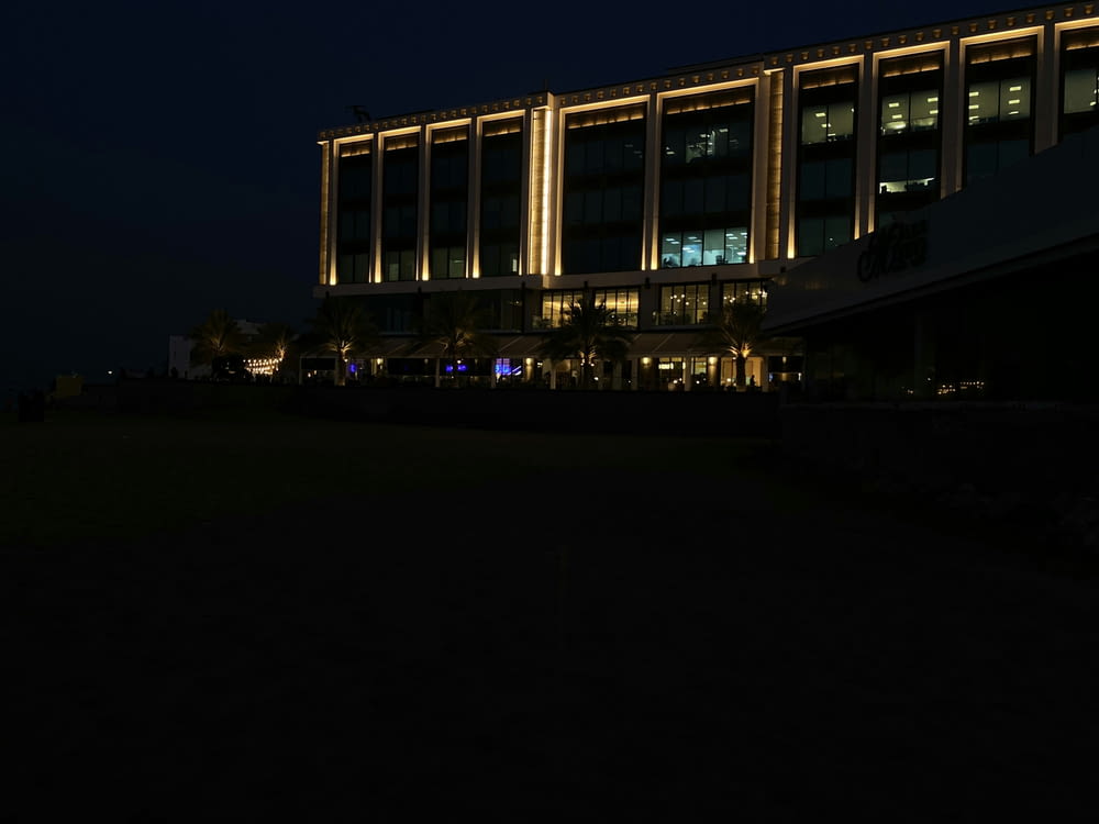 a large building lit up at night with lights on