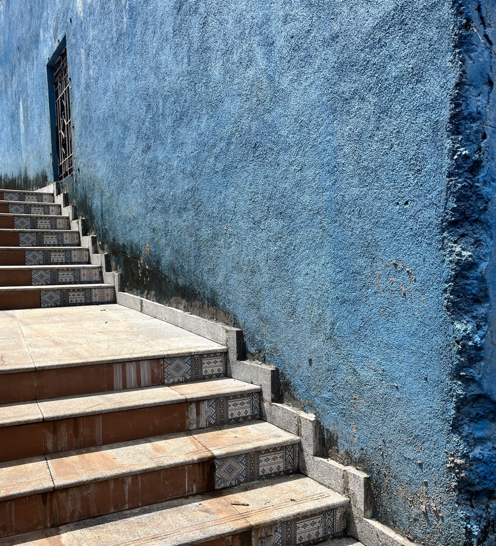 a set of steps leading up to a blue wall