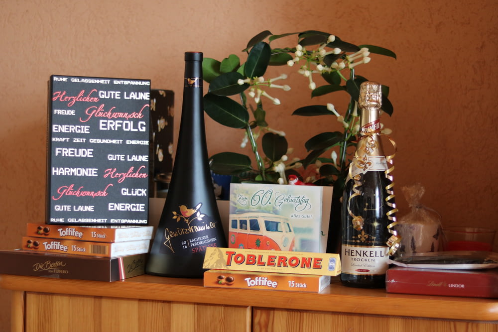 a table topped with bottles of wine and books