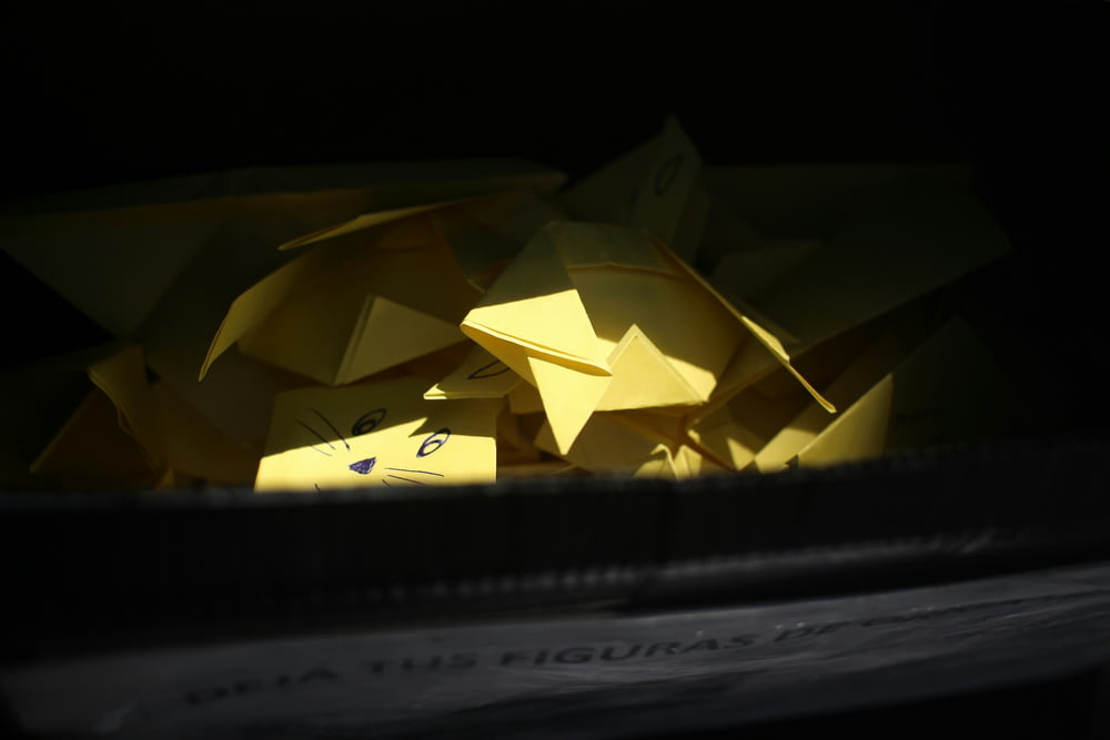 a box filled with yellow origami pieces
