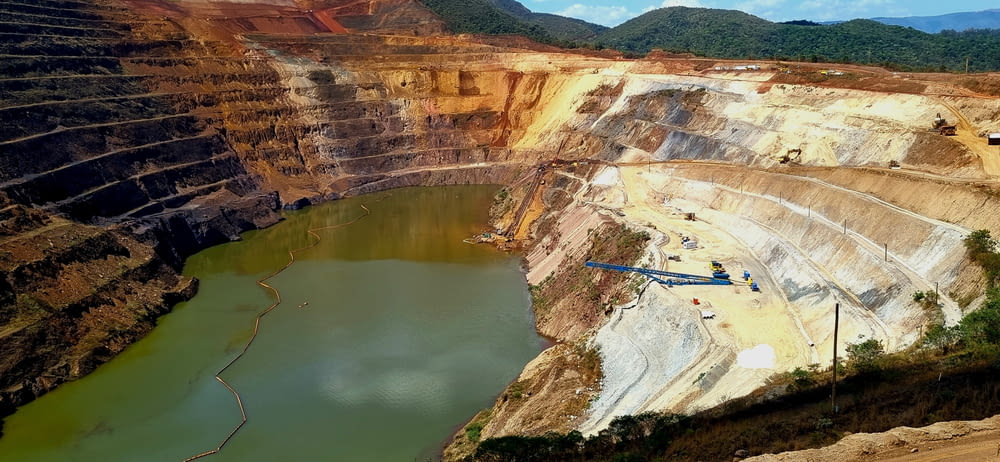 a large open pit with a large body of water
