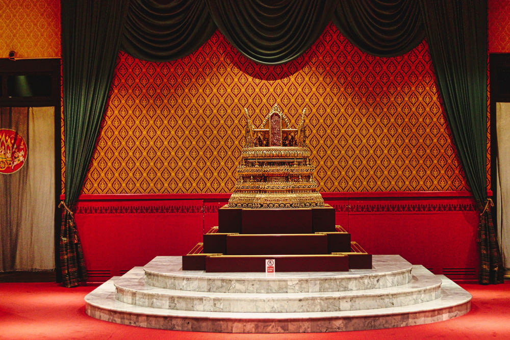 a large golden statue sitting on top of a stage