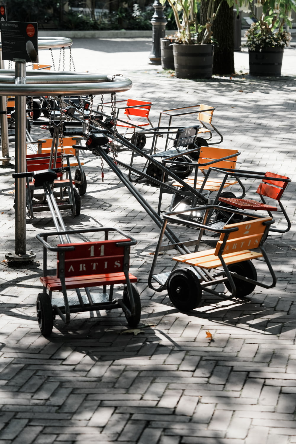 a row of carts sitting on top of a sidewalk
