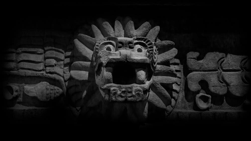 a black and white photo of a stone carving