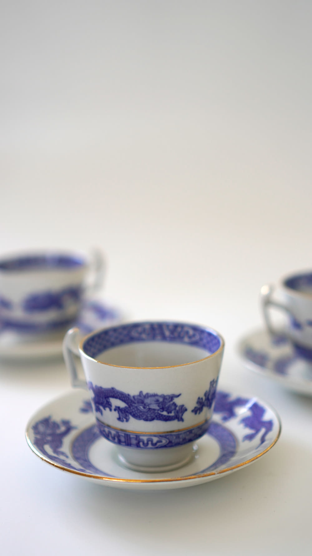 a blue and white tea cup and saucer