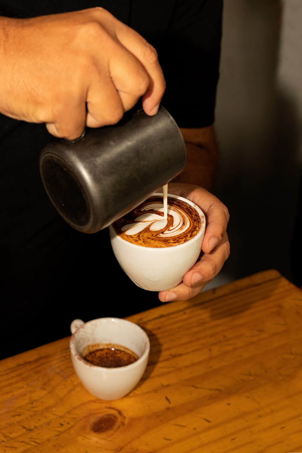 a person pours a cup of coffee