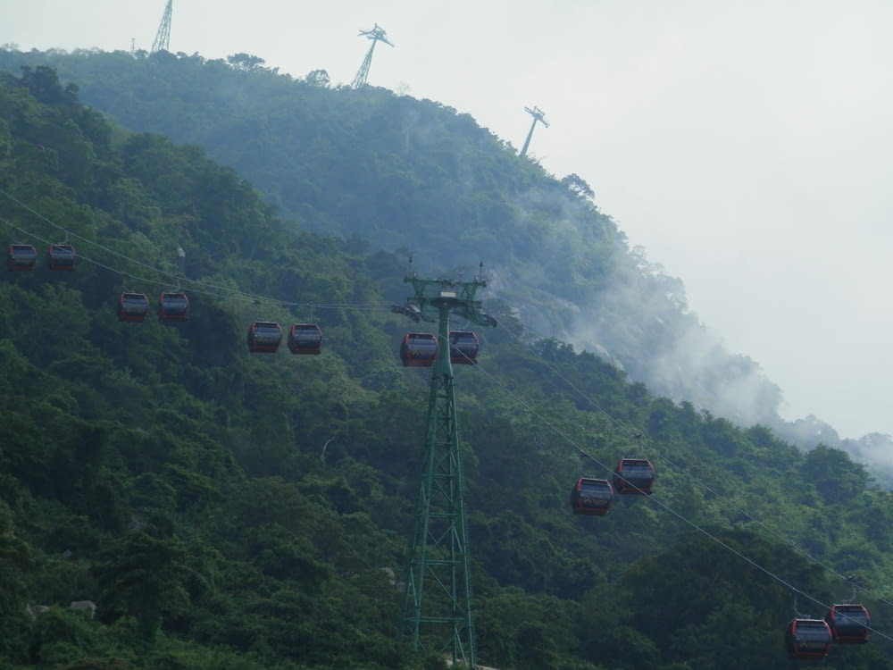 a group of gondola cars on a mountain side