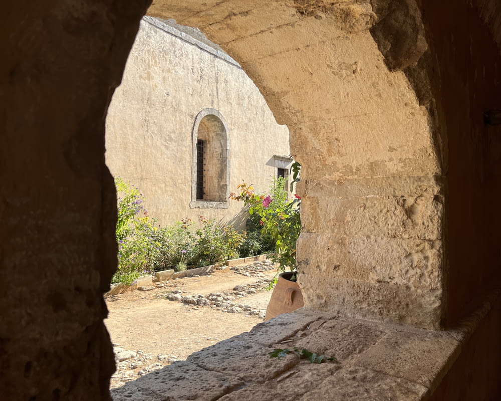 a view of a building through a stone archway