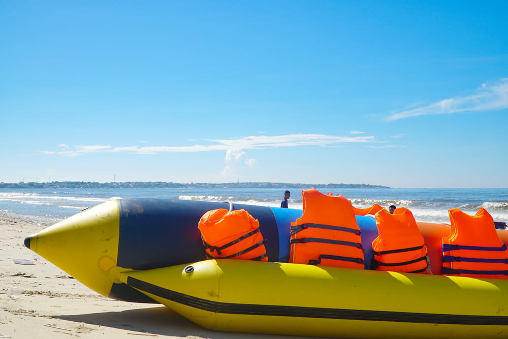 an inflatable raft on the beach with life vests on