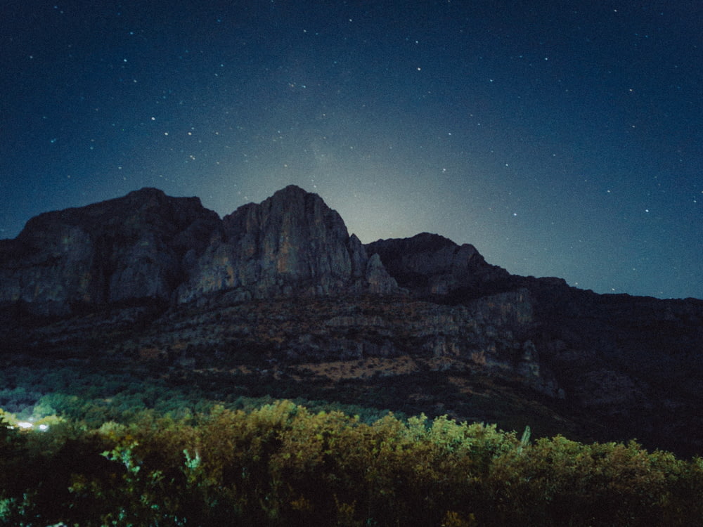 the night sky is full of stars above a mountain