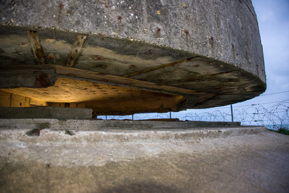 the bottom of a concrete structure under a bridge