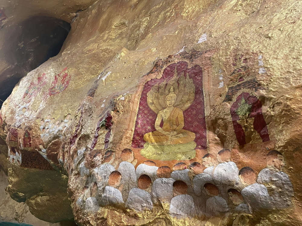a rock with a painting of a buddha on it