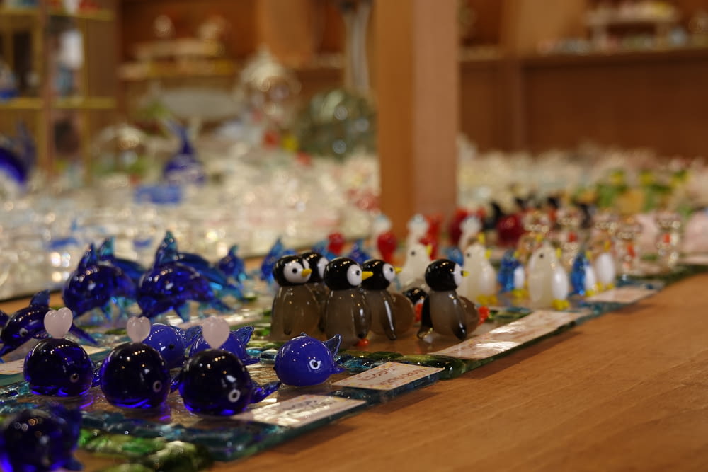 a group of glass figurines sitting on top of a wooden table