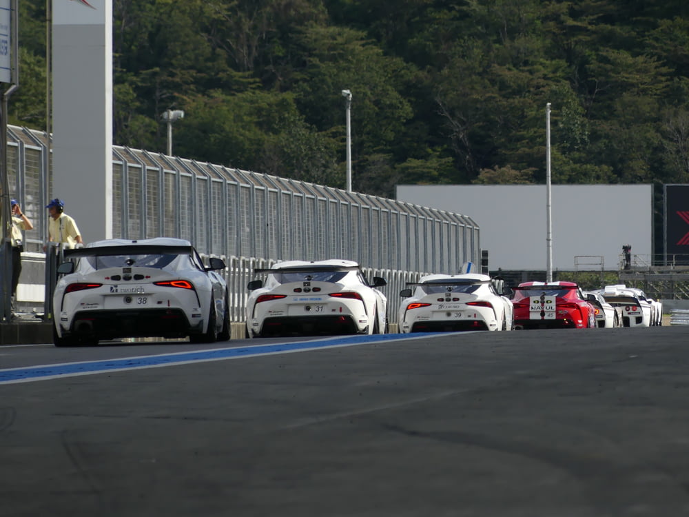 a group of cars parked on a race track