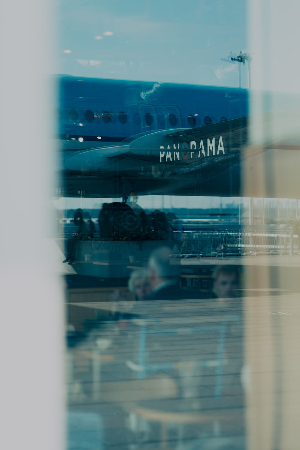 a pan ama airplane is seen through a window