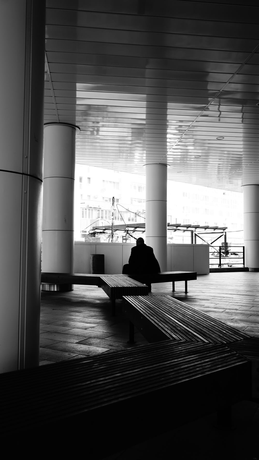 a person sitting on a bench in a building