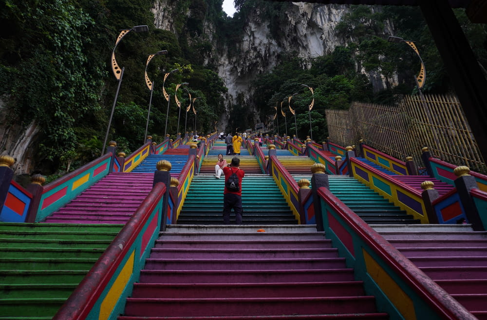 a man standing on top of a set of colorful stairs