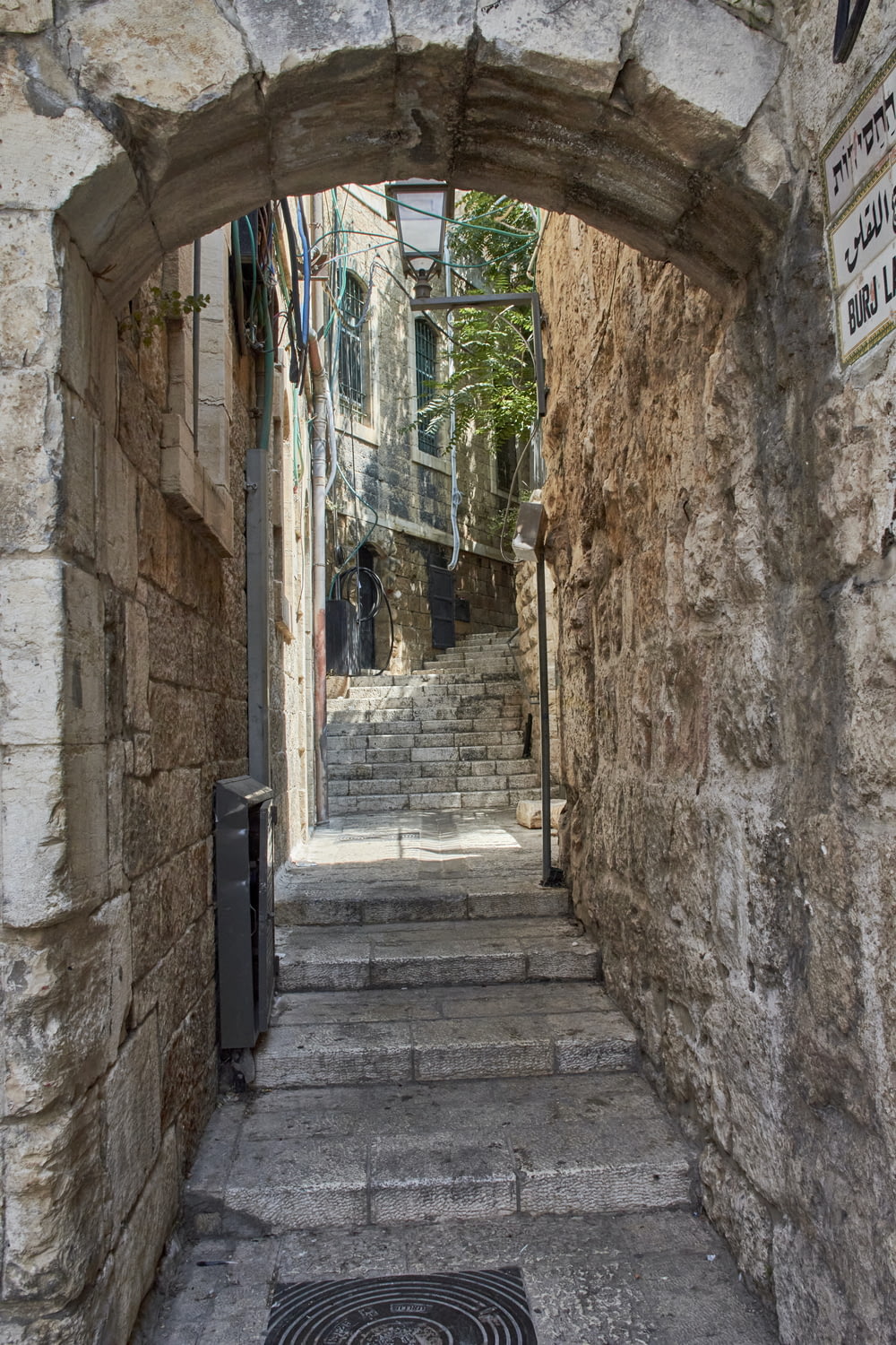 a narrow alleyway with stone walls and stairs