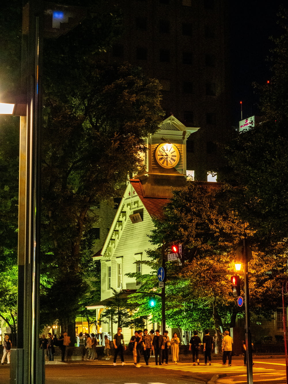 a clock tower in the middle of a city at night