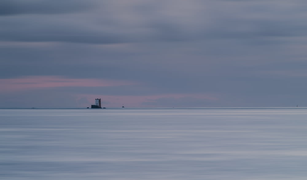 a lighthouse in the middle of a large body of water